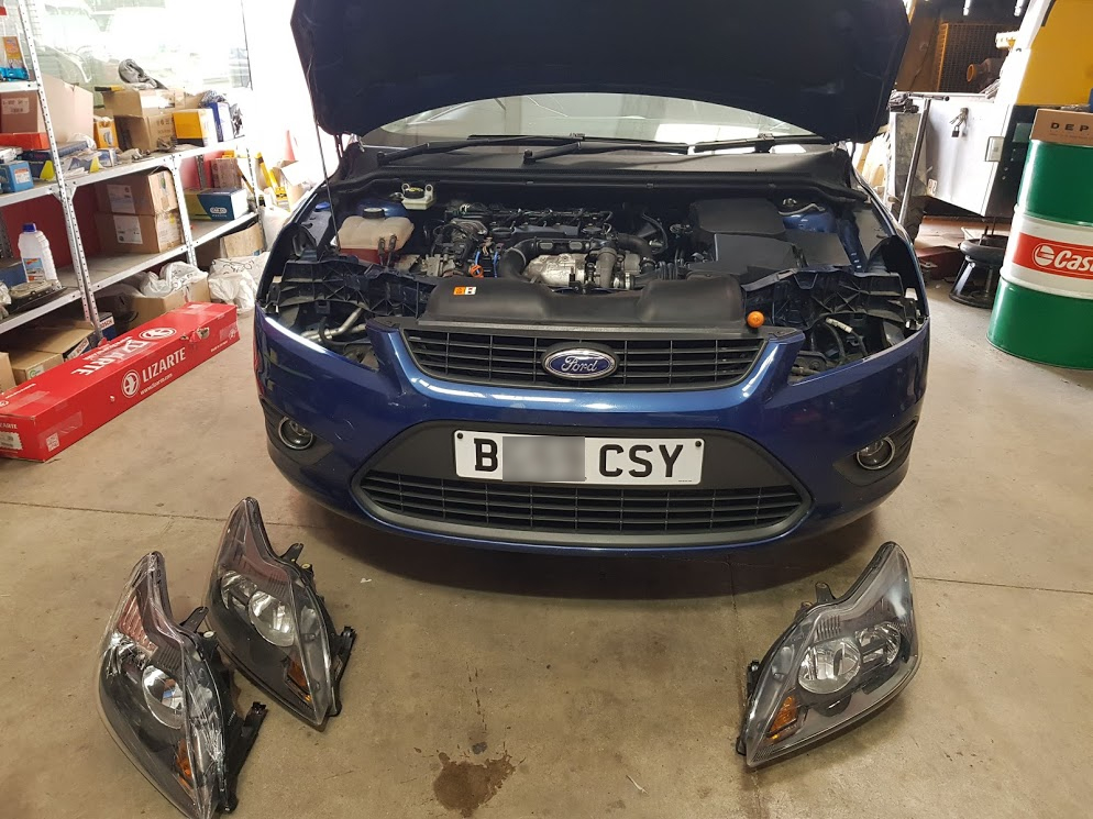 Ford Focus with headlights being changed Ford Focus with headlights out